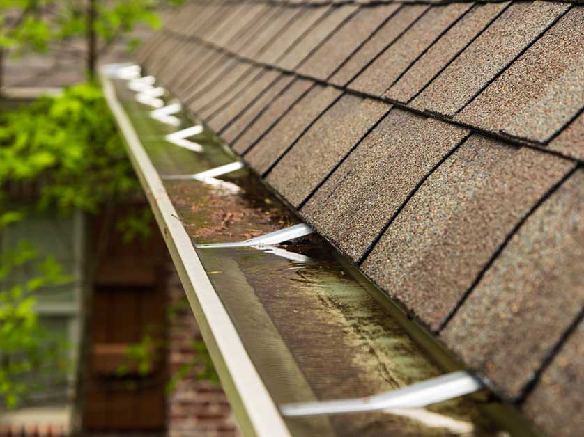 The Danger of Clogged Gutters: How Water Backups Destroy Your Roof